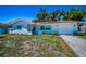 Beautiful single-story home featuring a red tile roof, an attached garage and a well-manicured front yard at 9952 111Th St, Seminole, FL 33772