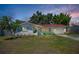 Charming single-story home featuring a red tile roof, an attached garage and a landscaped front yard at 9952 111Th St, Seminole, FL 33772
