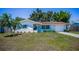 Beautiful single-story home featuring a red tile roof, an attached garage and a well-manicured front yard at 9952 111Th St, Seminole, FL 33772