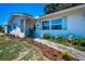 Charming front entrance with a decorative door, manicured landscaping, and a welcoming walkway at 9952 111Th St, Seminole, FL 33772