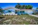 A delightful single-story home featuring a red tile roof, blue shutters, and a well-kept front yard at 9952 111Th St, Seminole, FL 33772