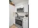 Modern kitchen with stainless steel appliances including stove, oven, and microwave, with white cabinetry at 9952 111Th St, Seminole, FL 33772