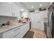 Bright kitchen with white cabinets, stainless steel appliances, granite countertops and subway tile backsplash at 9952 111Th St, Seminole, FL 33772