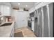 Stainless steel refrigerator and appliances, complemented by white cabinets and beige countertops at 9952 111Th St, Seminole, FL 33772