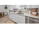 White kitchen sink with new stainless steel dishwasher, cabinets and drawers at 9952 111Th St, Seminole, FL 33772