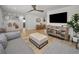 Open-concept living room with neutral decor, a modern entertainment center, and plenty of natural light at 9952 111Th St, Seminole, FL 33772