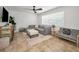 Comfortable living room featuring a sectional sofa, neutral decor, and tiled floors at 9952 111Th St, Seminole, FL 33772