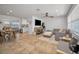 Spacious open-concept living room with dining area, tiled floors, and modern furniture at 9952 111Th St, Seminole, FL 33772
