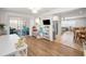 Open-concept living room with wood floors, lots of natural light, and access to outdoor patio at 9952 111Th St, Seminole, FL 33772