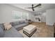 Bright and airy living room featuring neutral furniture, a ceiling fan, and a view of the entryway at 9952 111Th St, Seminole, FL 33772