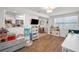 Open-concept living room features hardwood floors and a view to dining and kitchen at 9952 111Th St, Seminole, FL 33772
