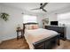 Comfortable bedroom with a ceiling fan, TV, and a large window offering plenty of natural light at 9952 111Th St, Seminole, FL 33772