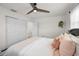 A bright bedroom features a ceiling fan, closet, and plenty of natural light at 9952 111Th St, Seminole, FL 33772
