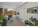 Inviting covered patio with seating area, striped rug, and plants, offering a relaxing outdoor space at 9952 111Th St, Seminole, FL 33772