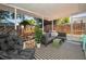 Comfortable covered patio with outdoor seating and backyard views including a swing set and basketball hoop at 9952 111Th St, Seminole, FL 33772
