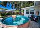 Outdoor stock tank pool surrounded by gravel, paired with seating for a relaxing backyard retreat at 9952 111Th St, Seminole, FL 33772