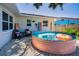 Backyard featuring a stock tank pool, accented with seating, and a surfboard decoration on the home's exterior at 9952 111Th St, Seminole, FL 33772
