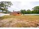 Exterior view of the home, featuring a large backyard and white picket fence at 3234 Morven Dr, Spring Hill, FL 34609