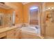 This bathroom features a glass shower stall and tub at 3234 Morven Dr, Spring Hill, FL 34609