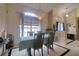 Bright dining area featuring an elegant chandelier and a large window at 3234 Morven Dr, Spring Hill, FL 34609