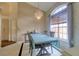 Bright dining area featuring elegant chandelier, neutral colors, and large window at 3234 Morven Dr, Spring Hill, FL 34609