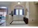 Bright foyer featuring tiled flooring, a decorative chandelier, and double door entryway at 3234 Morven Dr, Spring Hill, FL 34609
