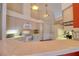 Well-lit kitchen featuring white countertops, appliances, and ample cabinet space, creating a clean aesthetic at 3234 Morven Dr, Spring Hill, FL 34609