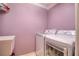 Efficient laundry room with a modern washer and dryer set, and clean sink basin at 3234 Morven Dr, Spring Hill, FL 34609