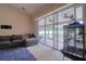 Spacious living room with a large sectional couch and access to a screened-in porch through sliding glass doors at 3234 Morven Dr, Spring Hill, FL 34609