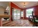 Bright office area with an adjacent screened porch featuring a desk by the window and wood floors at 3234 Morven Dr, Spring Hill, FL 34609