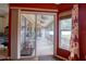 View of the screened back porch from inside the home with a sliding glass door and a large window at 3234 Morven Dr, Spring Hill, FL 34609