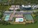 Aerial view of the community with a swimming pool and tennis courts on the lake at 10038 62Nd N Ter # 17, St Petersburg, FL 33708