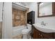 Cozy bathroom showcasing a tub with tiled walls, shower, vanity, and tiled floors at 10038 62Nd N Ter # 17, St Petersburg, FL 33708