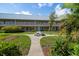 A well-maintained exterior view of the building with a manicured lawn and outdoor seating area for residents at 10038 62Nd N Ter # 17, St Petersburg, FL 33708