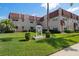 Attractive condo with a red tile roof, manicured lawn and tropical landscaping and signage at 10038 62Nd N Ter # 17, St Petersburg, FL 33708