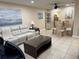The living room showcases a white leather sofa, glass-top tables, and a dining area with a glass table at 10038 62Nd N Ter # 17, St Petersburg, FL 33708