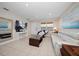Inviting living room featuring a plush sofa, a television, and a window with natural light at 10038 62Nd N Ter # 17, St Petersburg, FL 33708
