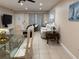 Open concept living room and dining area features light tile flooring, neutral paint, and modern furnishings at 10038 62Nd N Ter # 17, St Petersburg, FL 33708