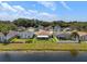 Aerial view of home overlooking a serene lake and lush greenery in the neighborhood at 10205 Charleston Corner Rd, Tampa, FL 33635