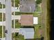Aerial view of rooftops and lawns facing a pond in a residential community at 10205 Charleston Corner Rd, Tampa, FL 33635