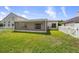 A well-maintained lawn and screened in patio surrounded by a white picket fence at 10205 Charleston Corner Rd, Tampa, FL 33635