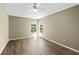 Cozy bedroom with neutral walls and updated flooring boasts two windows overlooking the landscaped yard at 10205 Charleston Corner Rd, Tampa, FL 33635