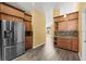 Kitchen with stainless steel fridge and cabinets with laminate floors at 10205 Charleston Corner Rd, Tampa, FL 33635