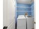 Bright laundry room features washer, dryer, and built-in shelving for convenient storage at 10205 Charleston Corner Rd, Tampa, FL 33635