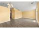 Open-concept living room features laminate flooring, neutral walls, and contemporary lighting at 10205 Charleston Corner Rd, Tampa, FL 33635
