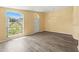 Spacious living room with new laminate flooring and views of the landscaped front yard at 10205 Charleston Corner Rd, Tampa, FL 33635