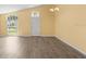 Bright living room with new laminate flooring, large windows, and natural light at 10205 Charleston Corner Rd, Tampa, FL 33635