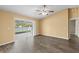 Open concept living room features updated flooring and sliding glass doors to the screened in lanai with a pond view at 10205 Charleston Corner Rd, Tampa, FL 33635