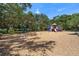 View of a playground with swings, slides, and wood chip ground cover at 10205 Charleston Corner Rd, Tampa, FL 33635
