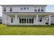 A spacious backyard featuring a covered patio with floor-to-ceiling sliding glass doors at 10320 Longmeadow Ave, Parrish, FL 34219